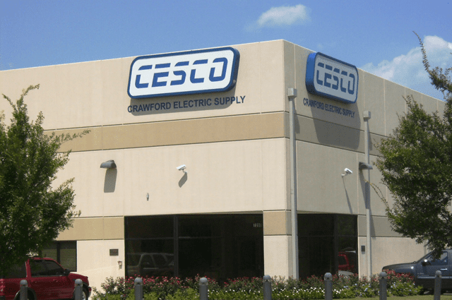 A building with a beige exterior and a sign titled CESCO Crawford Electric Supply